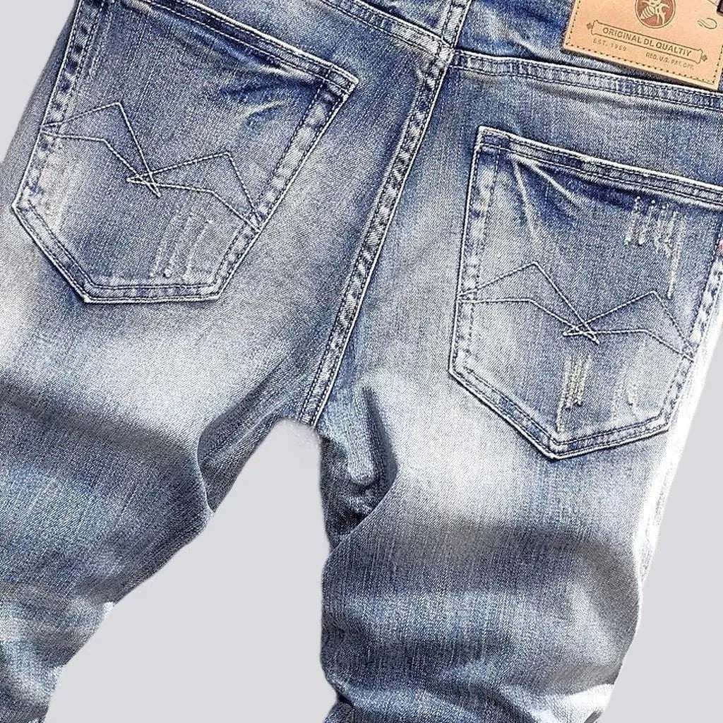 Slightly men's torn jeans