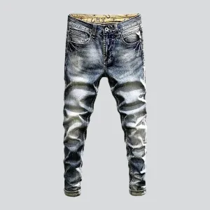 Slightly men's torn jeans